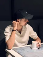 Issa at a cafe, coffee in hand